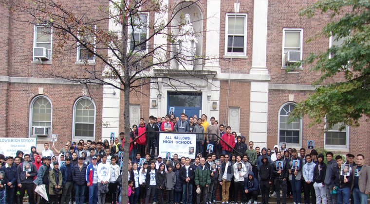 The entire group of participants in the front of the school, including Joshua’s family members in the center of the photo