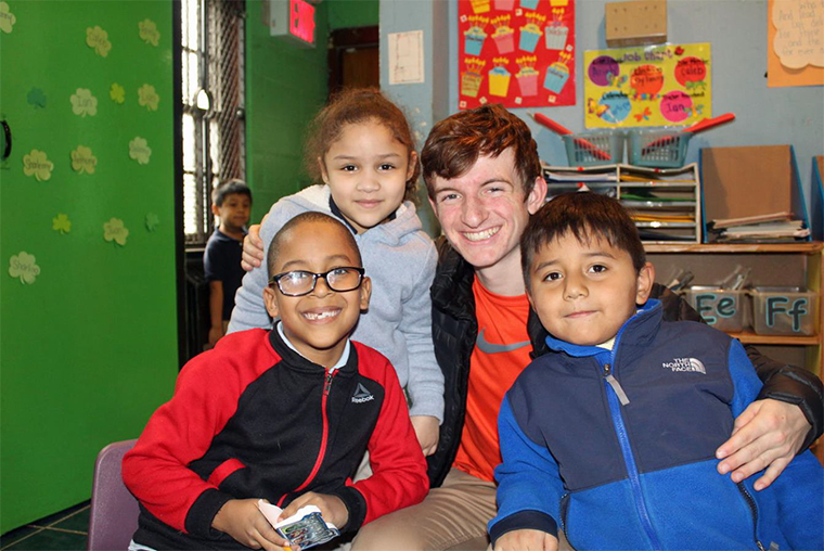 Vancouver College student Scott Brown with children at a public school in New York.