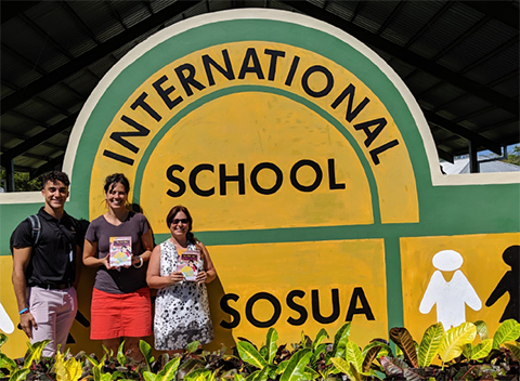 Angelo visits with staff members at the International School of Sosua, one of the many locations where he distributed copies of the book.