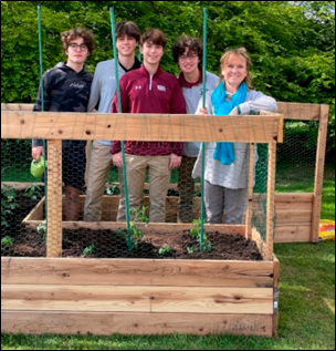 Iona Prep students and ACTION Moderator Mrs. Chana show off their newly constructed community garden on campus.