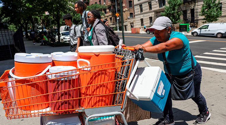 A woman pushes a shopping cart full of coolers and cold beverages during a summer heatwave in New York City July 11, 2024. Seventeen U.S. states set annual heat records in 2024, the hottest year to date. (OSV News/Reuters/Caitlin Ochs)